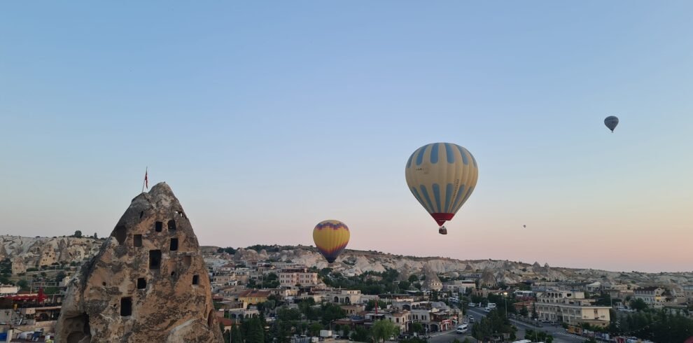 a couple of hot air balloons flying over a city