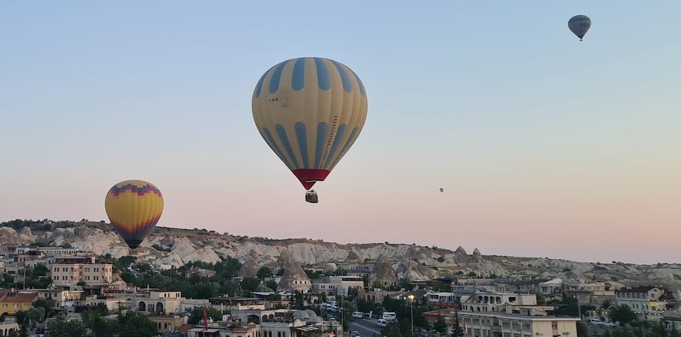 a couple of hot air balloons flying over a city